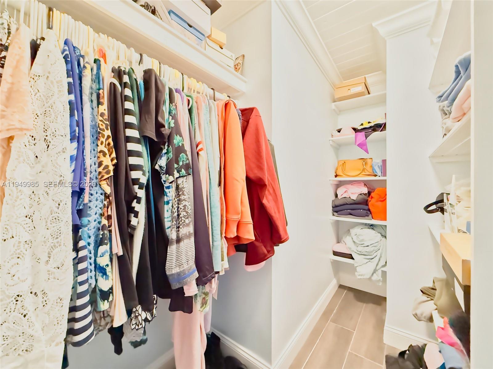 19280 Southwest 304th Street Homestead, FL 33030 - Photo 24 of 57 a view of walk in closet with clothes and shoes