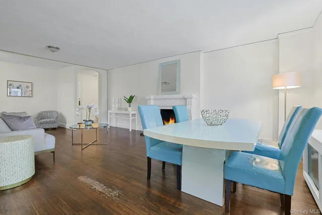 a living room with furniture a fireplace and a table