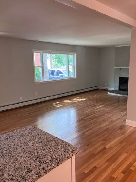44 Great Elm Road Billerica, MA 01821 - Photo 8 of 15 an empty room with wooden floor and windows
