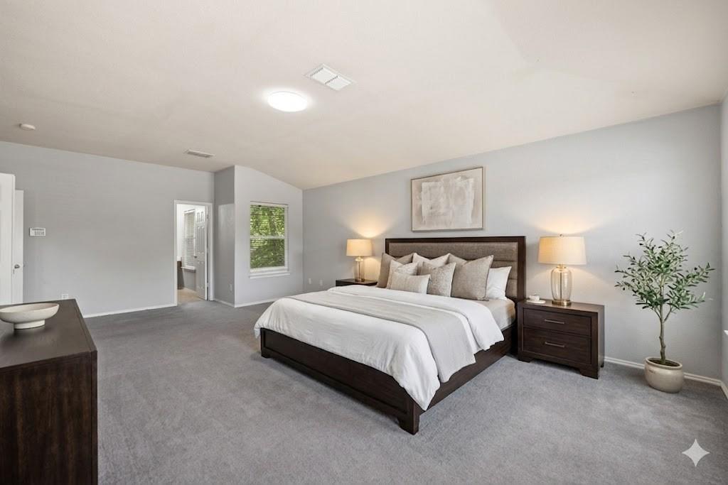 601 Amy Way Euless, TX 76039 - Photo 6 of 40 a spacious bedroom with a bed and a potted plant