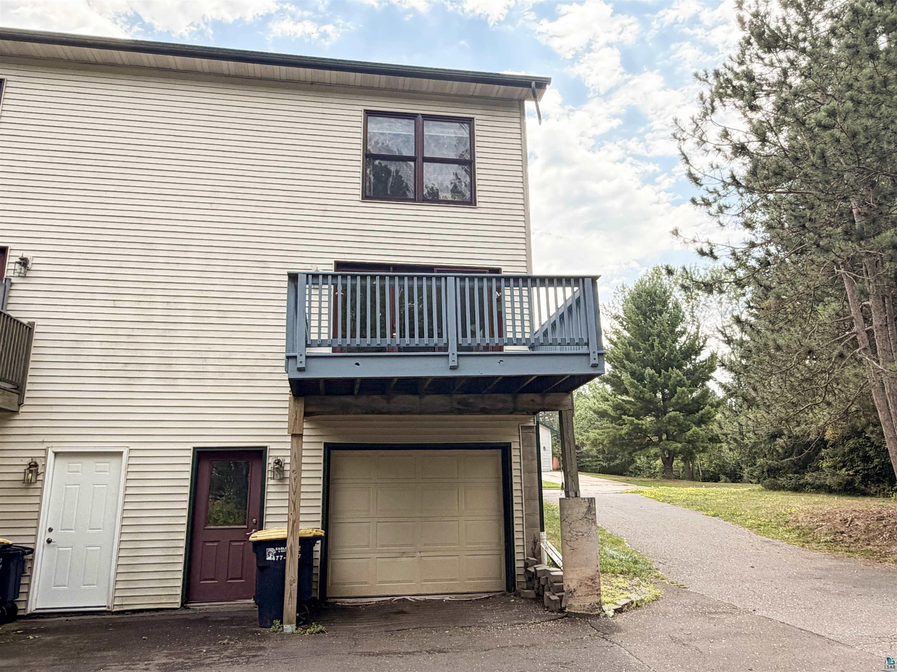 109 Prentice Heights Road, Unit 2 Ashland, WI 54806 - Photo 17 of 23 Upper-level deck with wood railing, attached garage, and ground-level entryway