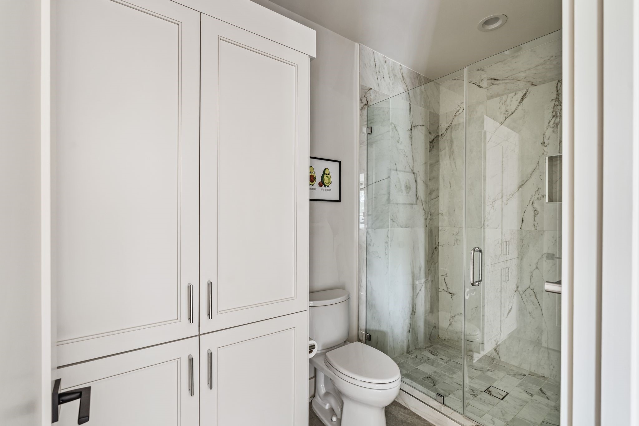 4638 Merwin Street Houston, TX 77027 - Photo 30 of 42 Beautiful tilework highlights the glass-enclosed walk-in shower.