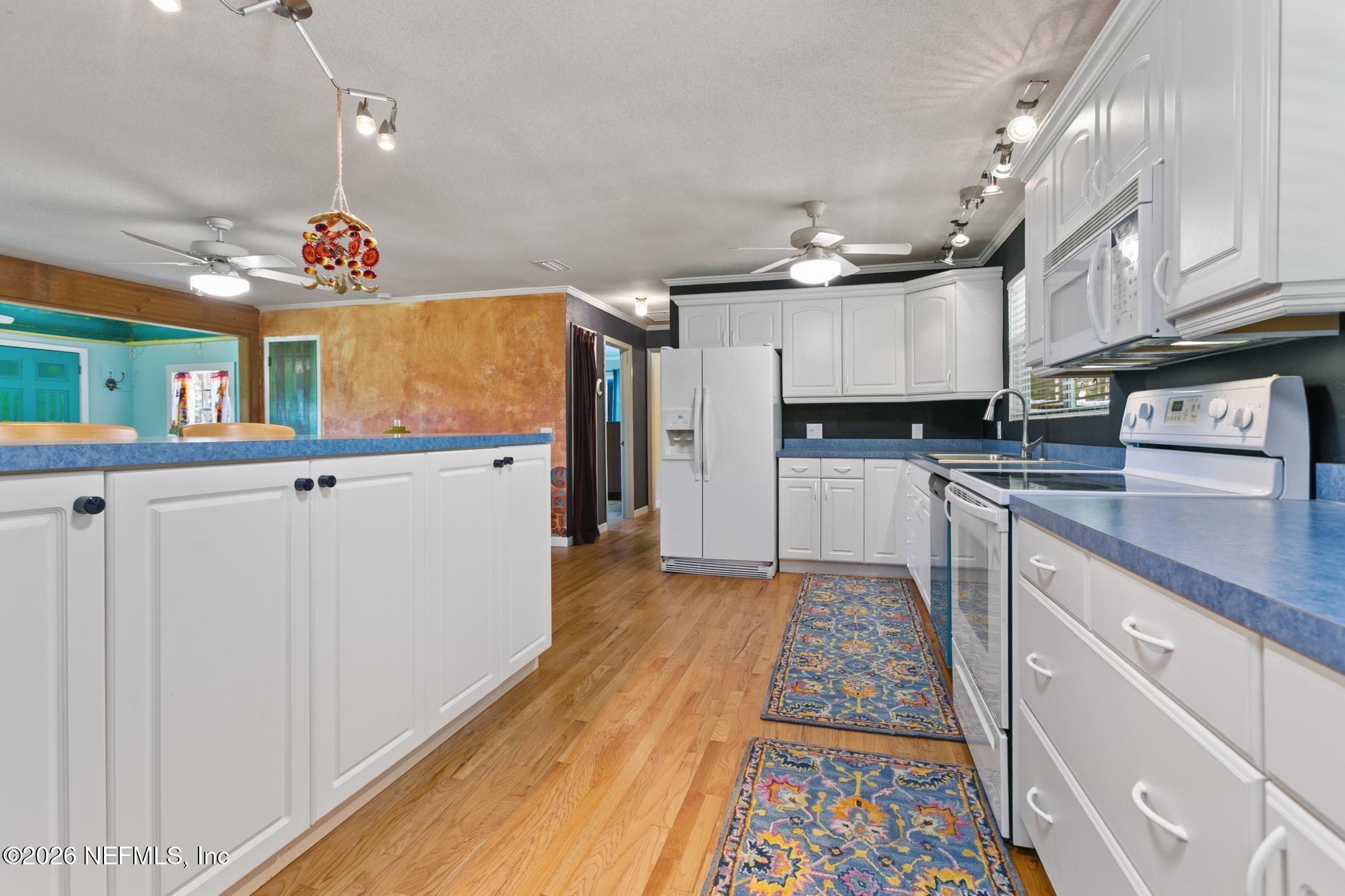 958-954 Grand Rondo Crescent City, FL 32112 - Photo 18 of 29 a kitchen with granite countertop a sink and cabinets