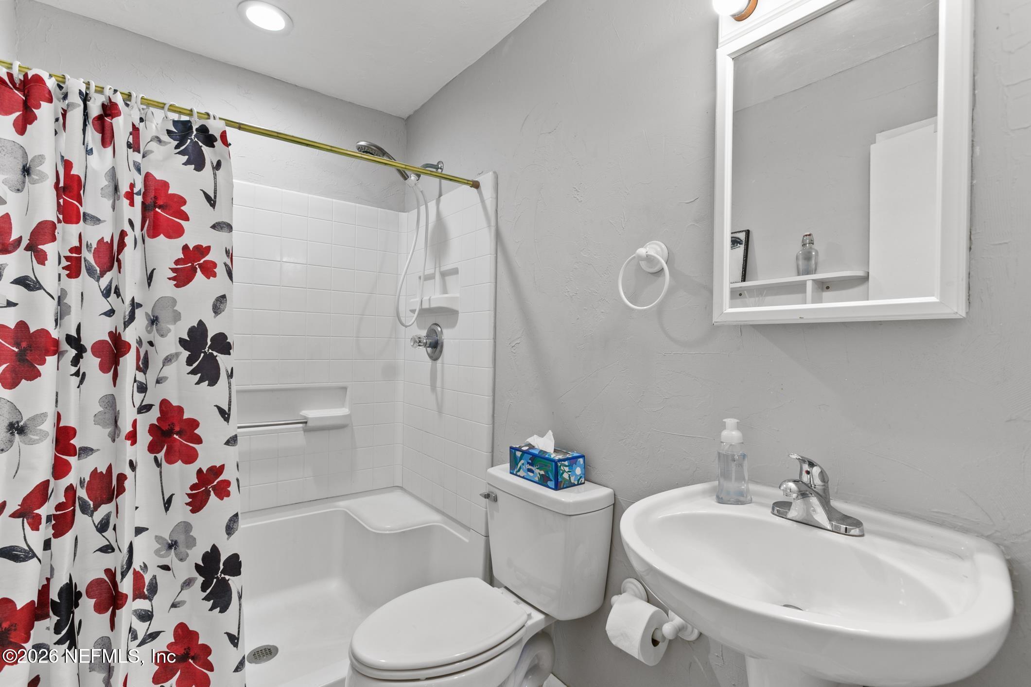 958-954 Grand Rondo Crescent City, FL 32112 - Photo 23 of 29 a bathroom with a sink a toilet and shower curtain