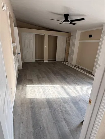 a view of a room with wooden floor and outdoor space