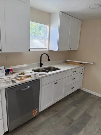 a kitchen with appliances cabinets and a sink