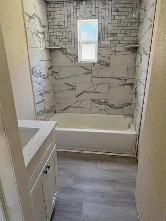 a bathroom with a bathtub and a shower