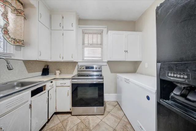 a kitchen with cabinets appliances and a sink