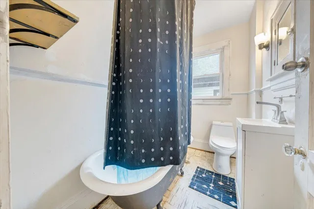 a bathroom with a toilet a sink and shower