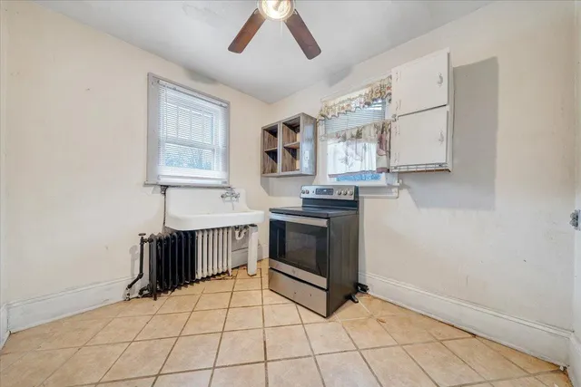 a kitchen with a stove a sink and a microwave