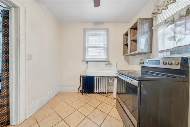 a kitchen with stainless steel appliances a stove a sink and a refrigerator