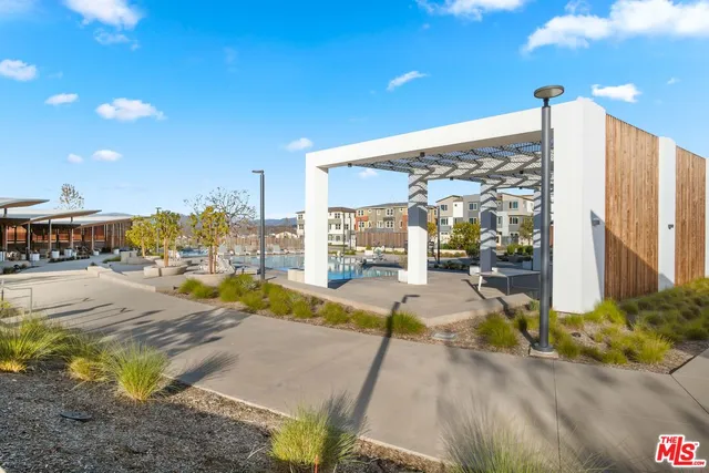 a view of backyard with swimming pool and outdoor seating