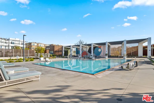 a view of a patio with a table and chairs under an umbrella