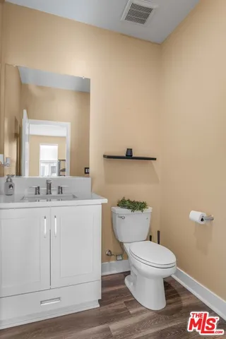 a white toilet sitting next to a bathroom sink