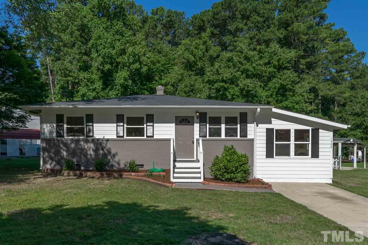 1500 Kelly Road Garner, NC 27529 - Photo 1 of 21 a front view of a house with a garden and porch