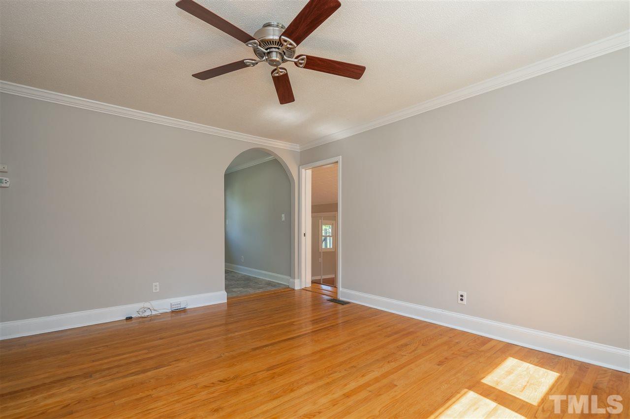1500 Kelly Road Garner, NC 27529 - Photo 4 of 21 an empty room with wooden floor fan and windows
