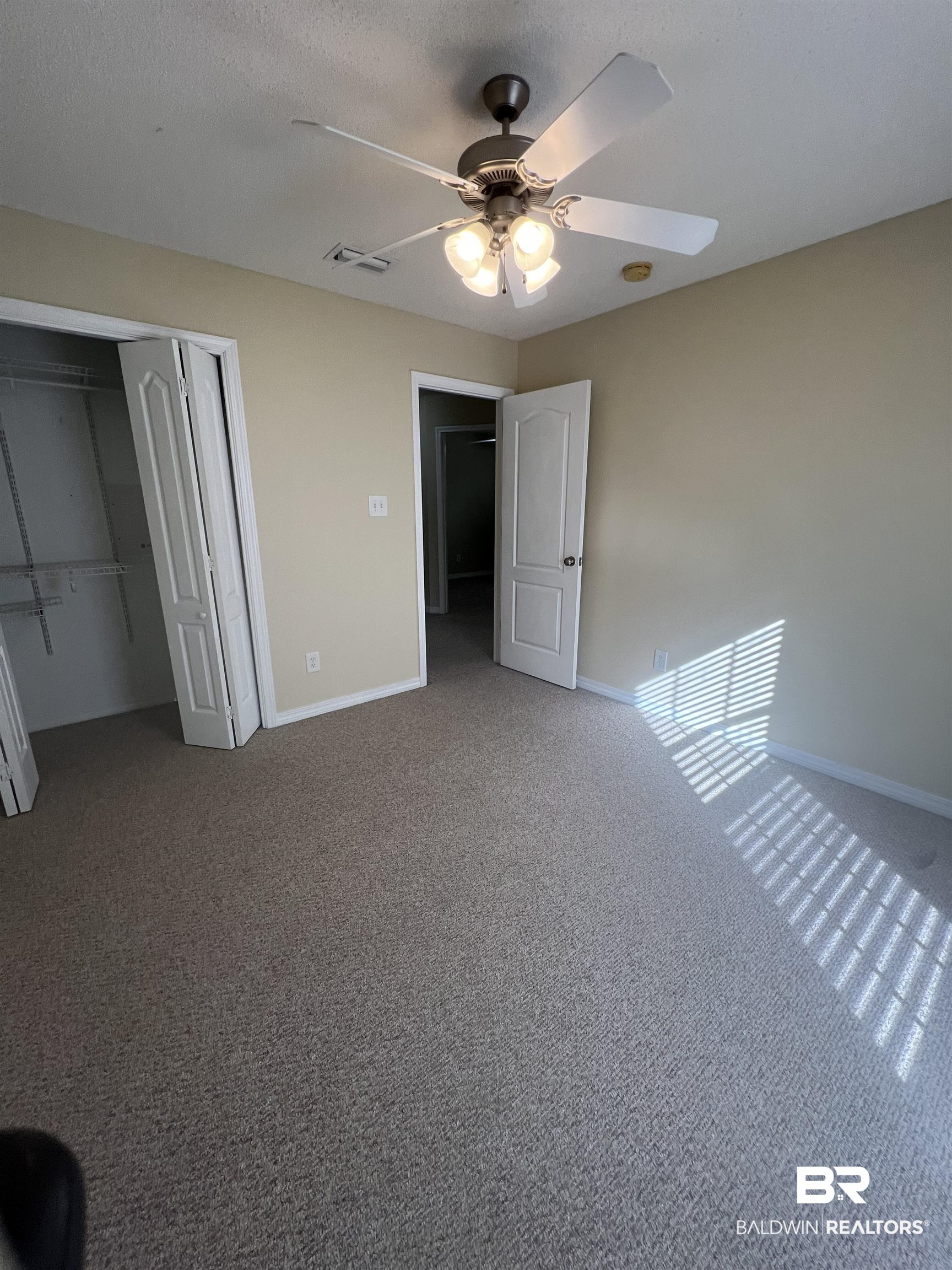 17793 Fancy Boulevard Foley, AL 36535 - Photo 29 of 34 Unfurnished bedroom featuring carpet, a textured ceiling, ceiling fan, and a closet