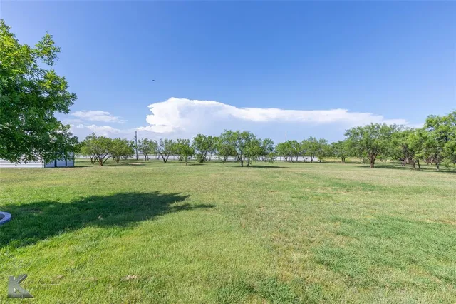 a view of a lake with a yard