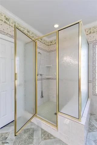 a bathroom with a glass shower door