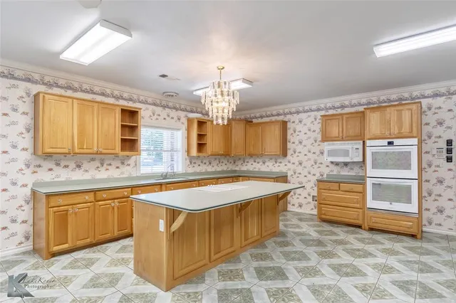a spacious bathroom with a tub double sink and a mirror
