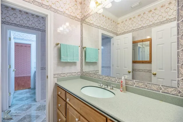 a bathroom with a sink double vanity and a mirror