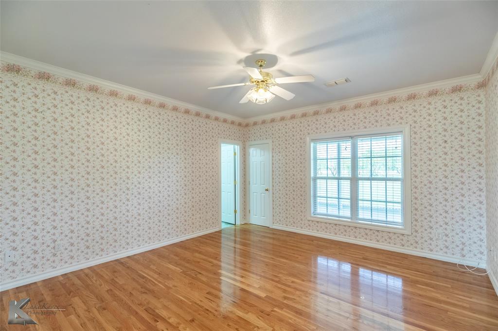 13063 Rainey Ridge Lane Abilene, TX 79602 - Photo 30 of 40 wooden floor in an empty room with a window
