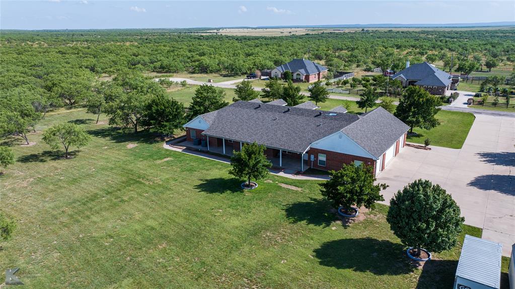 13063 Rainey Ridge Lane Abilene, TX 79602 - Photo 35 of 40 a view of a house with a yard and potted plants
