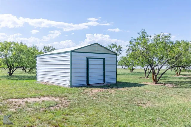 a front view of a house with a garden and yard