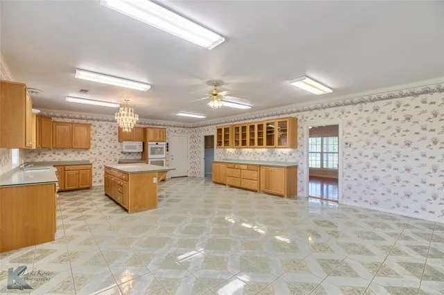 a view of kitchen with table and chairs