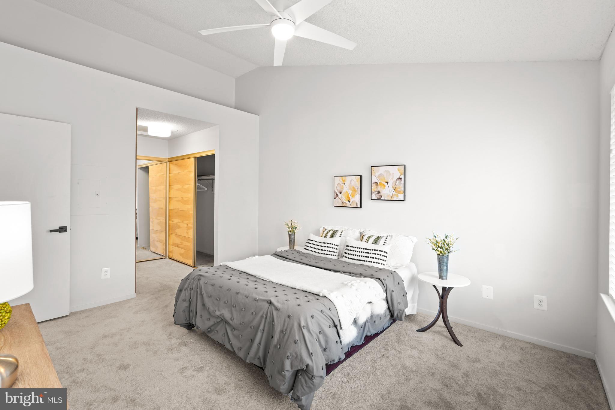 11731 Summerchase Circle, Unit 1731E Reston, VA 20194 - Photo 12 of 30 a bedroom with a bed and a chandelier