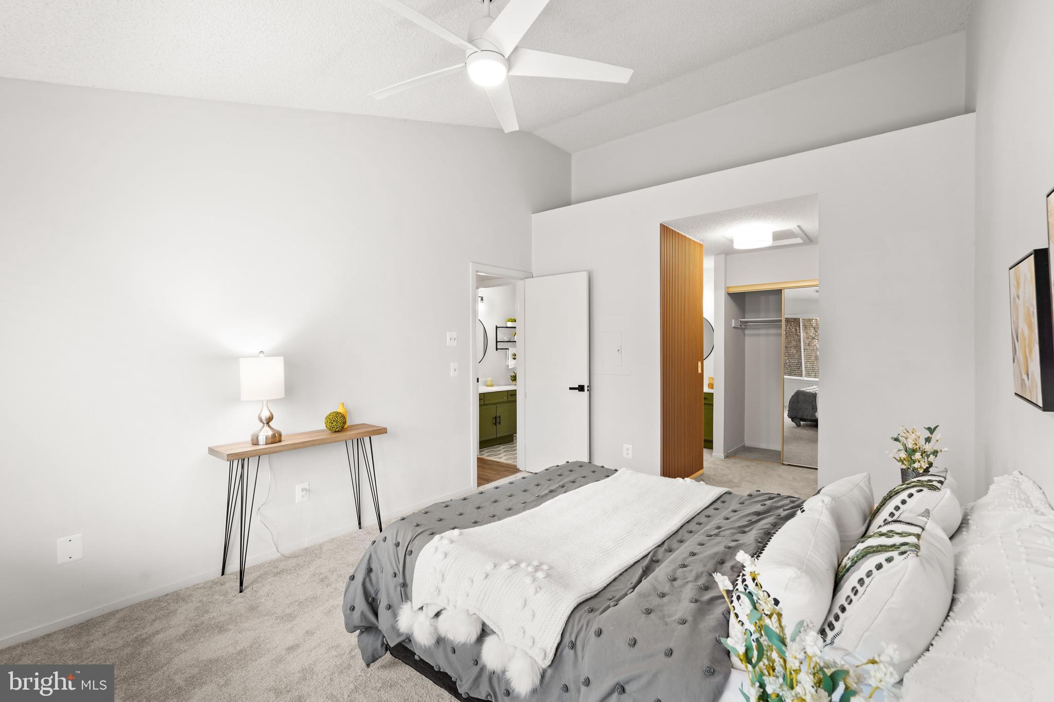 11731 Summerchase Circle, Unit 1731E Reston, VA 20194 - Photo 13 of 30 a bedroom with a bed and a table in it