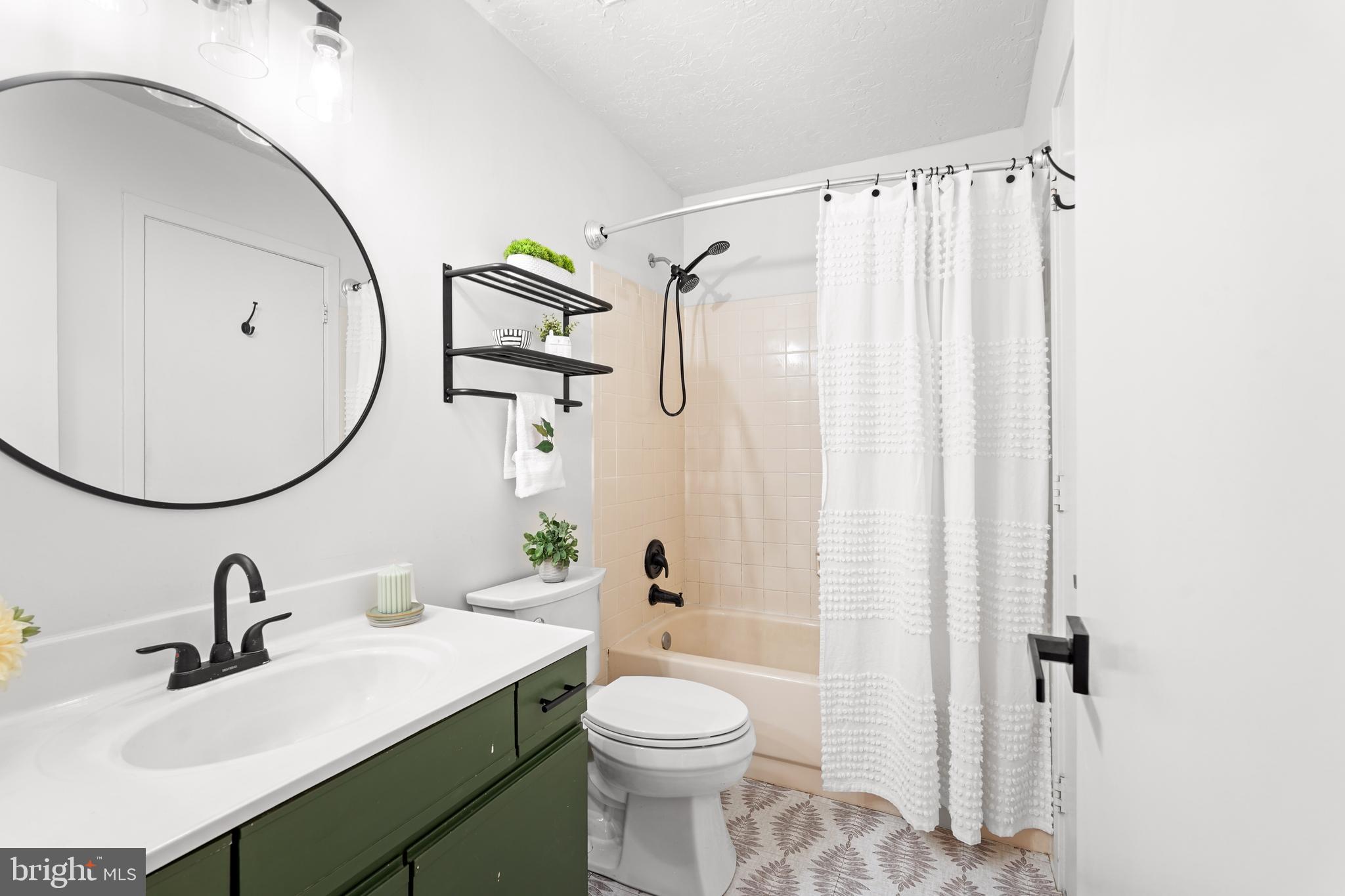 11731 Summerchase Circle, Unit 1731E Reston, VA 20194 - Photo 17 of 30 a bathroom with a sink vanity mirror and toilet