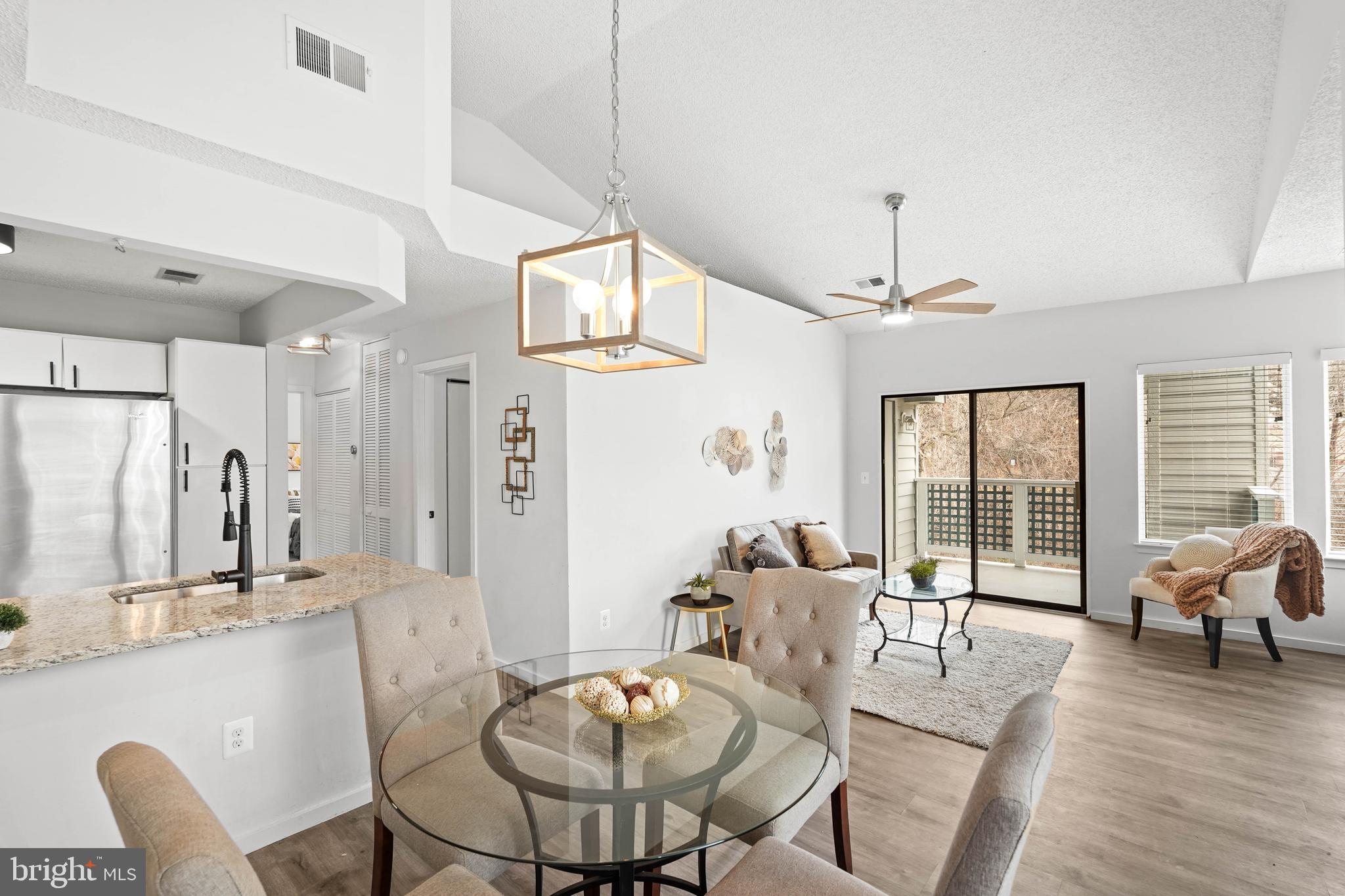 11731 Summerchase Circle, Unit 1731E Reston, VA 20194 - Photo 30 of 30 a living room with furniture large window and wooden floor