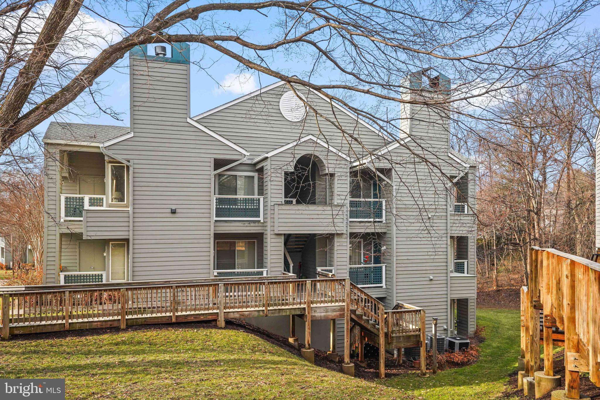 11731 Summerchase Circle, Unit 1731E Reston, VA 20194 - Photo 27 of 30 a view of a house with pool and chairs