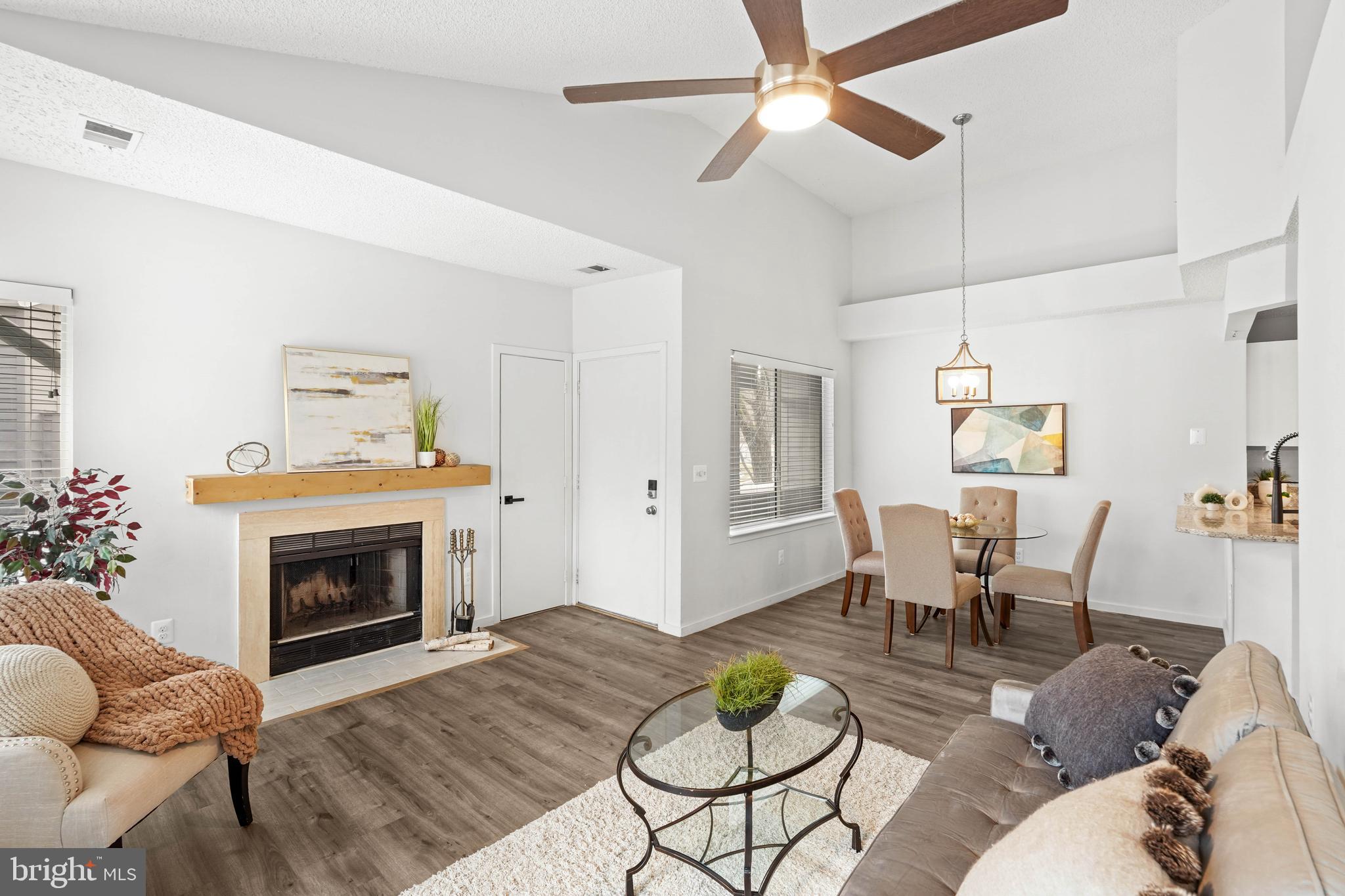 11731 Summerchase Circle, Unit 1731E Reston, VA 20194 - Photo 3 of 30 a living room with furniture and a fireplace