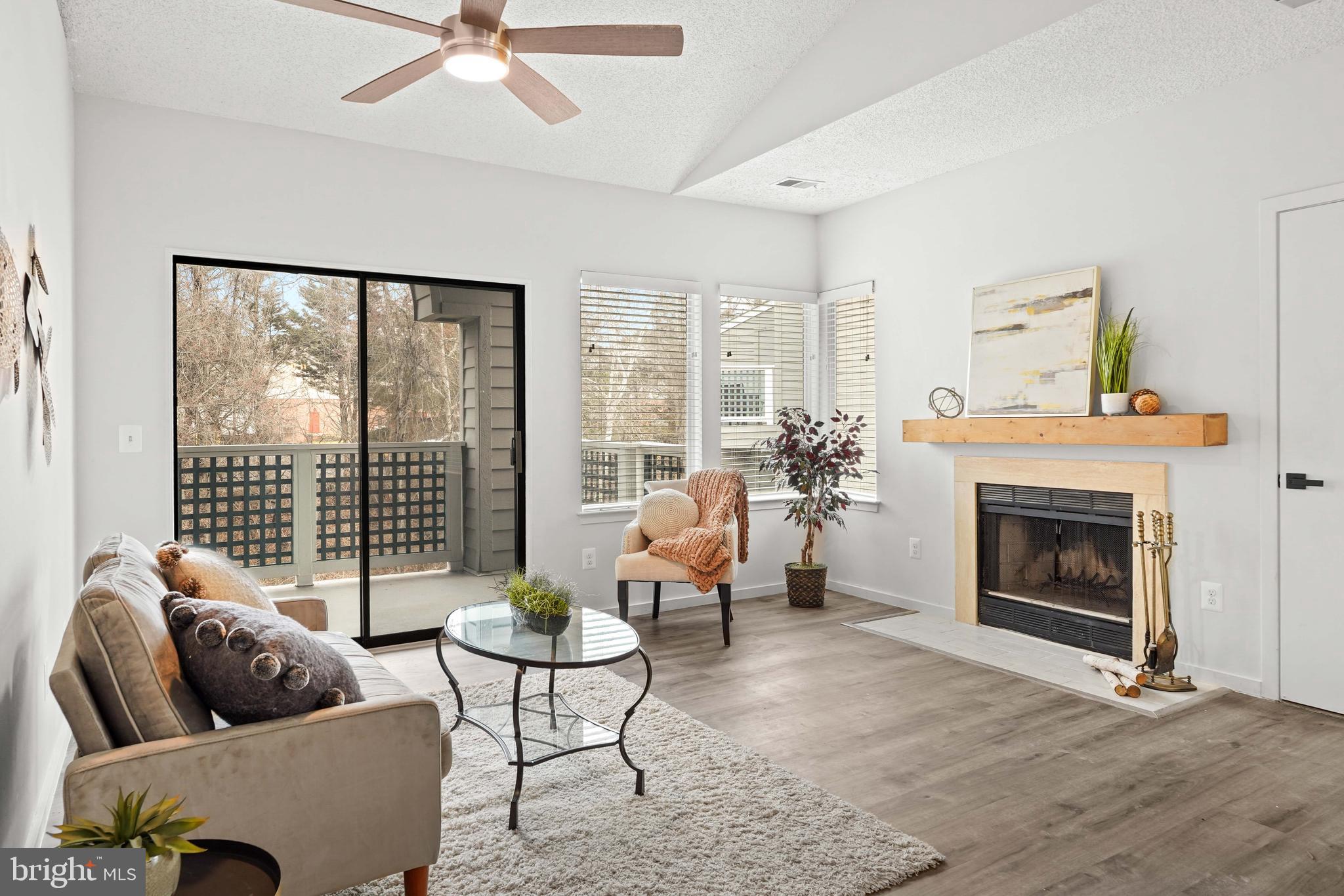11731 Summerchase Circle, Unit 1731E Reston, VA 20194 - Photo 4 of 30 a living room with furniture and a fireplace