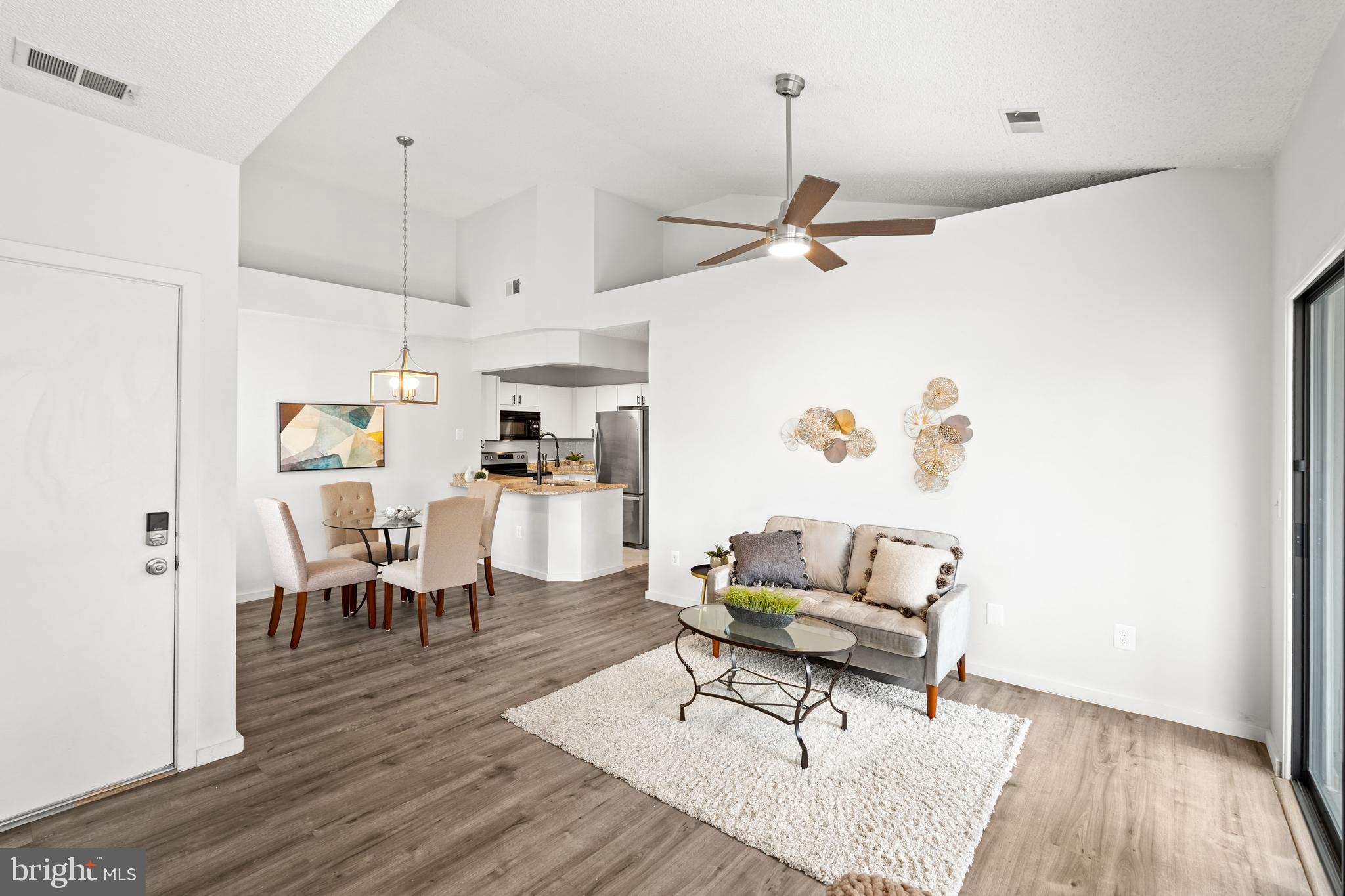 11731 Summerchase Circle, Unit 1731E Reston, VA 20194 - Photo 5 of 30 a living room with furniture and a wooden floor