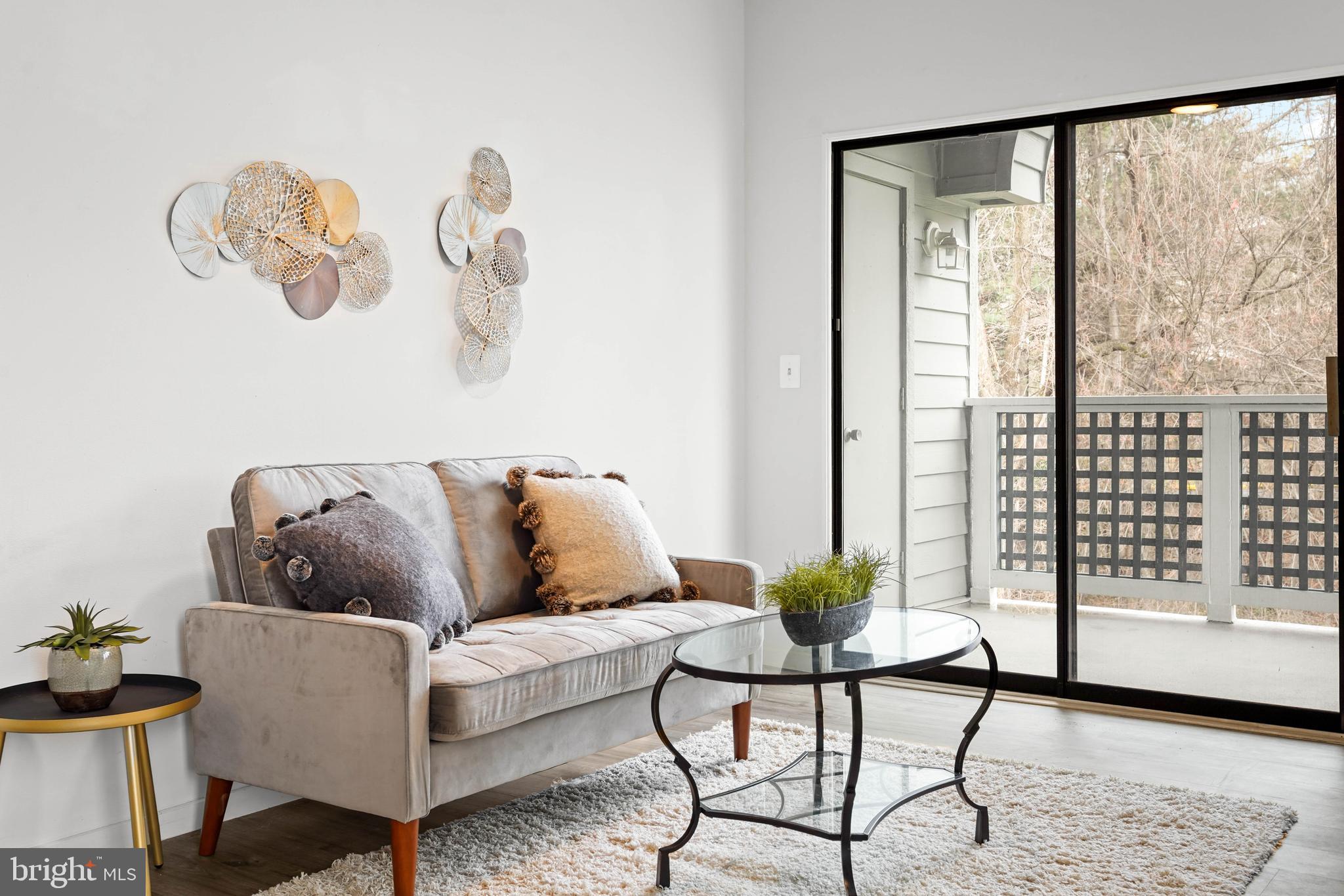 11731 Summerchase Circle, Unit 1731E Reston, VA 20194 - Photo 6 of 30 a living room with furniture and a window