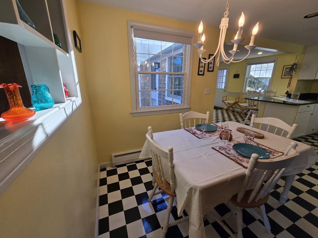 15 Woodside Park Road West Dennis, MA 02670 - Photo 11 of 35 a dining room with a table and chairs