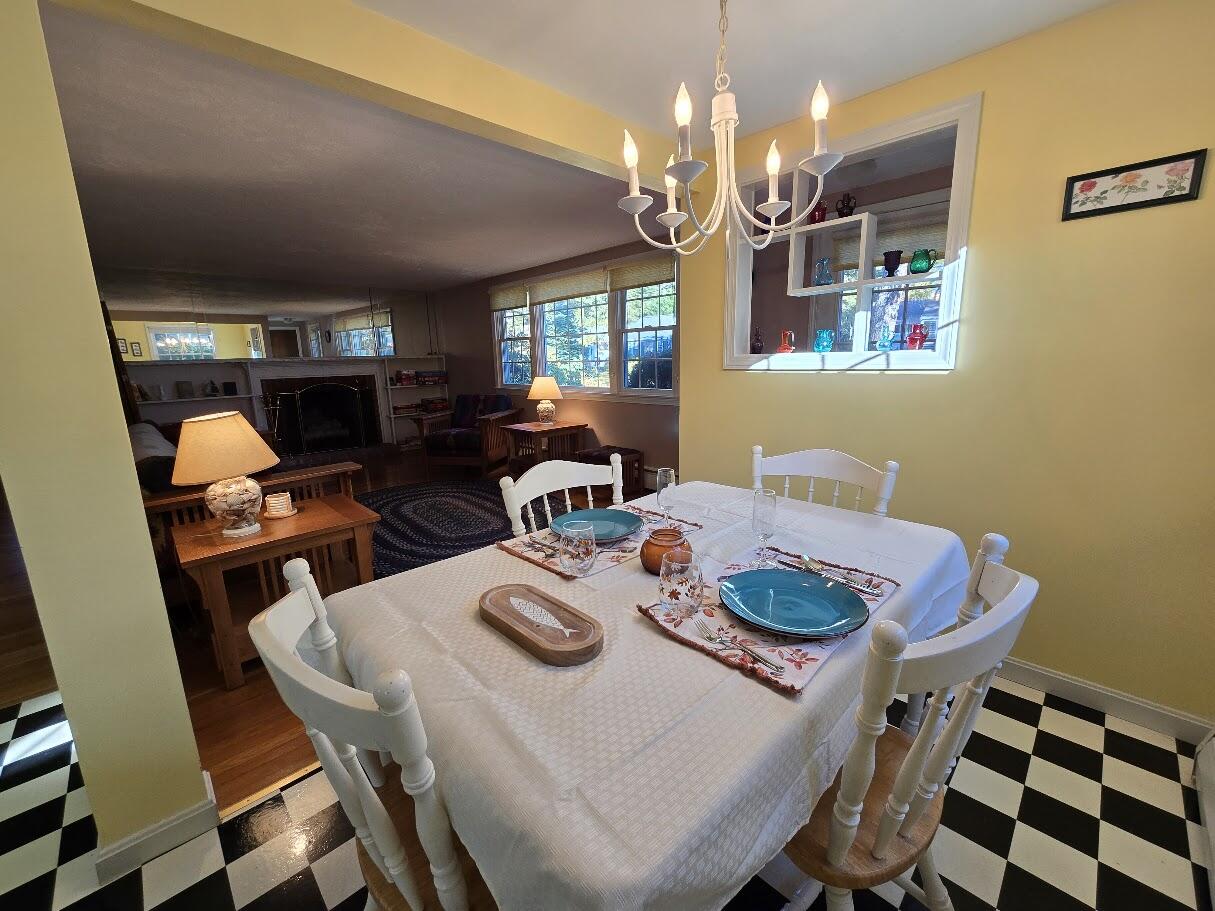 15 Woodside Park Road West Dennis, MA 02670 - Photo 12 of 35 a view of a dining room with furniture a chandelier and window