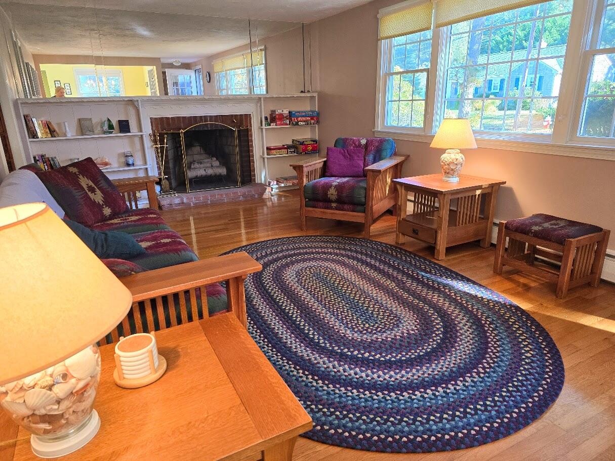 15 Woodside Park Road West Dennis, MA 02670 - Photo 13 of 35 a living room with furniture a window and a fireplace
