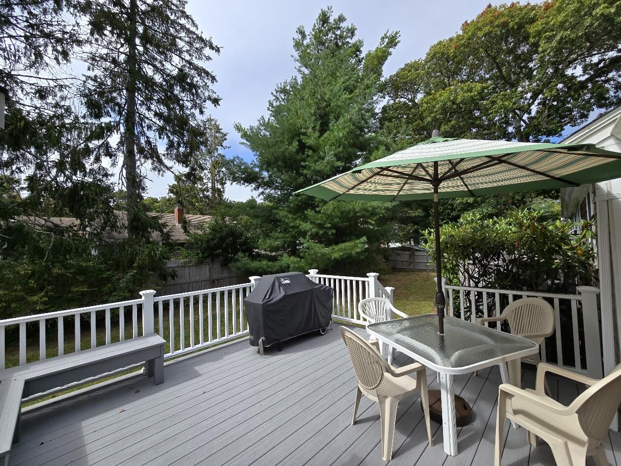 15 Woodside Park Road West Dennis, MA 02670 - Photo 2 of 35 a view of a chair and table on the wooden floor