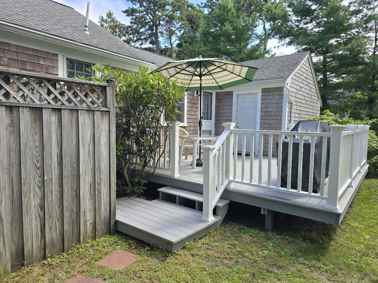 15 Woodside Park Road West Dennis, MA 02670 - Photo 27 of 35 a view of a chair and table in backyard