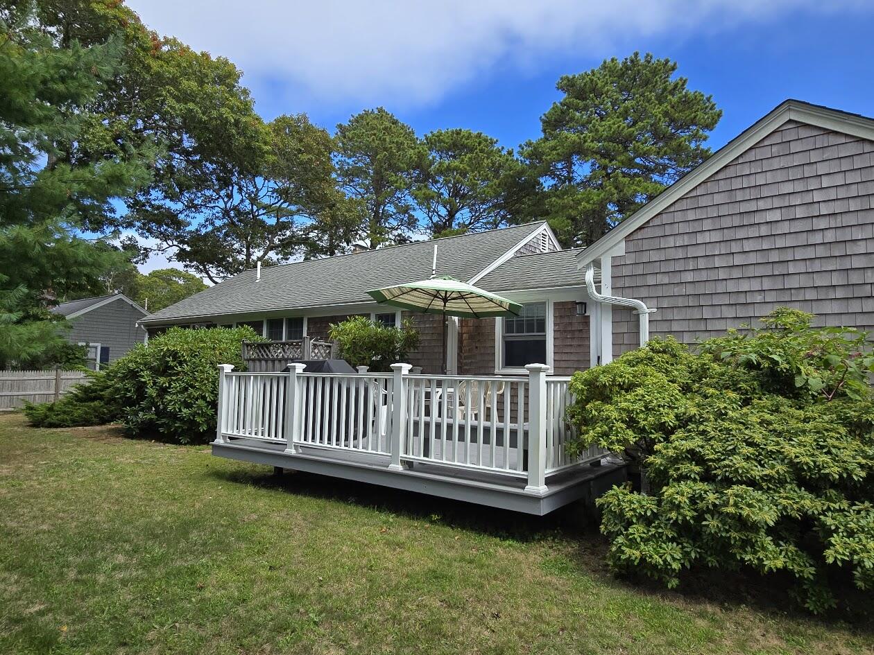 15 Woodside Park Road West Dennis, MA 02670 - Photo 28 of 35 a view of a house with a yard and a garden