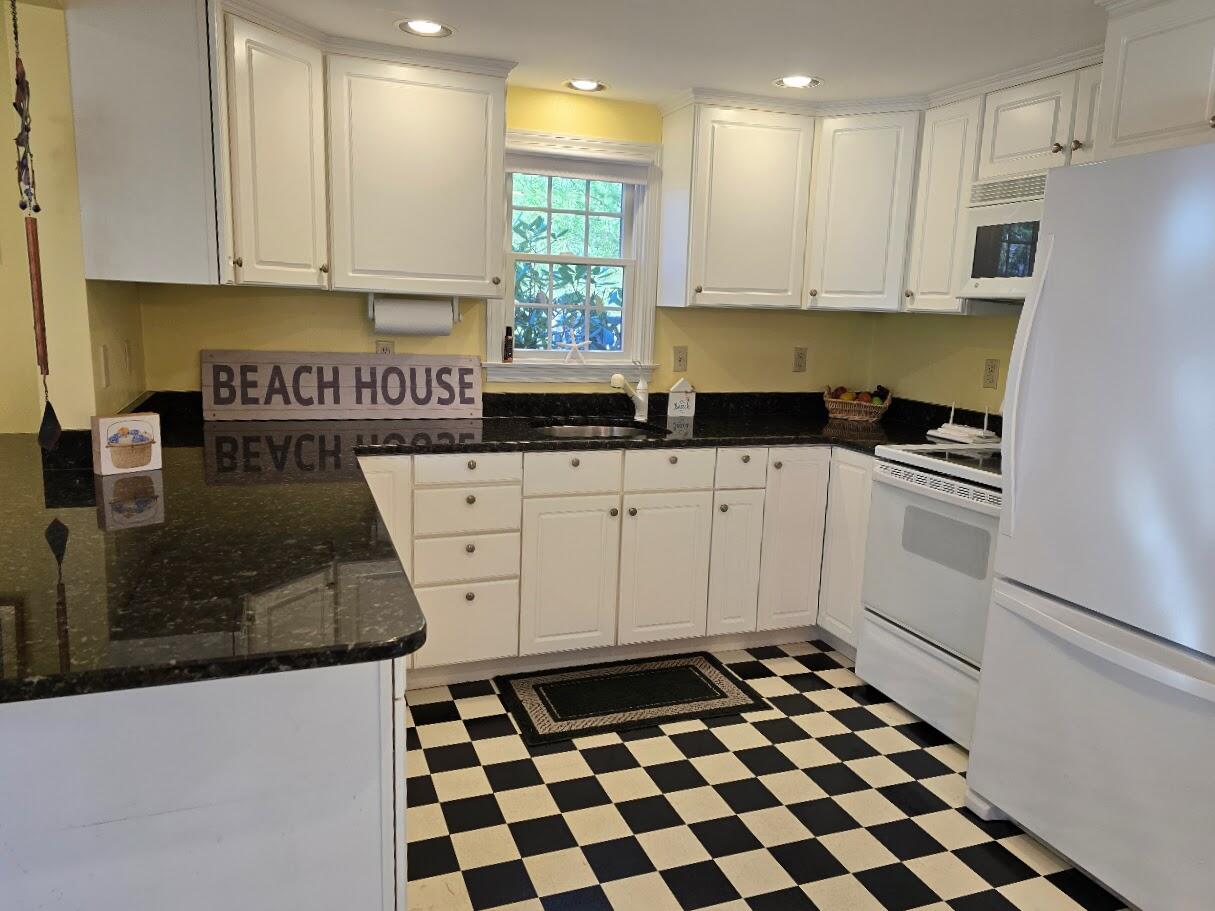 15 Woodside Park Road West Dennis, MA 02670 - Photo 4 of 35 a kitchen with granite countertop a sink a stove a refrigerator and cabinets
