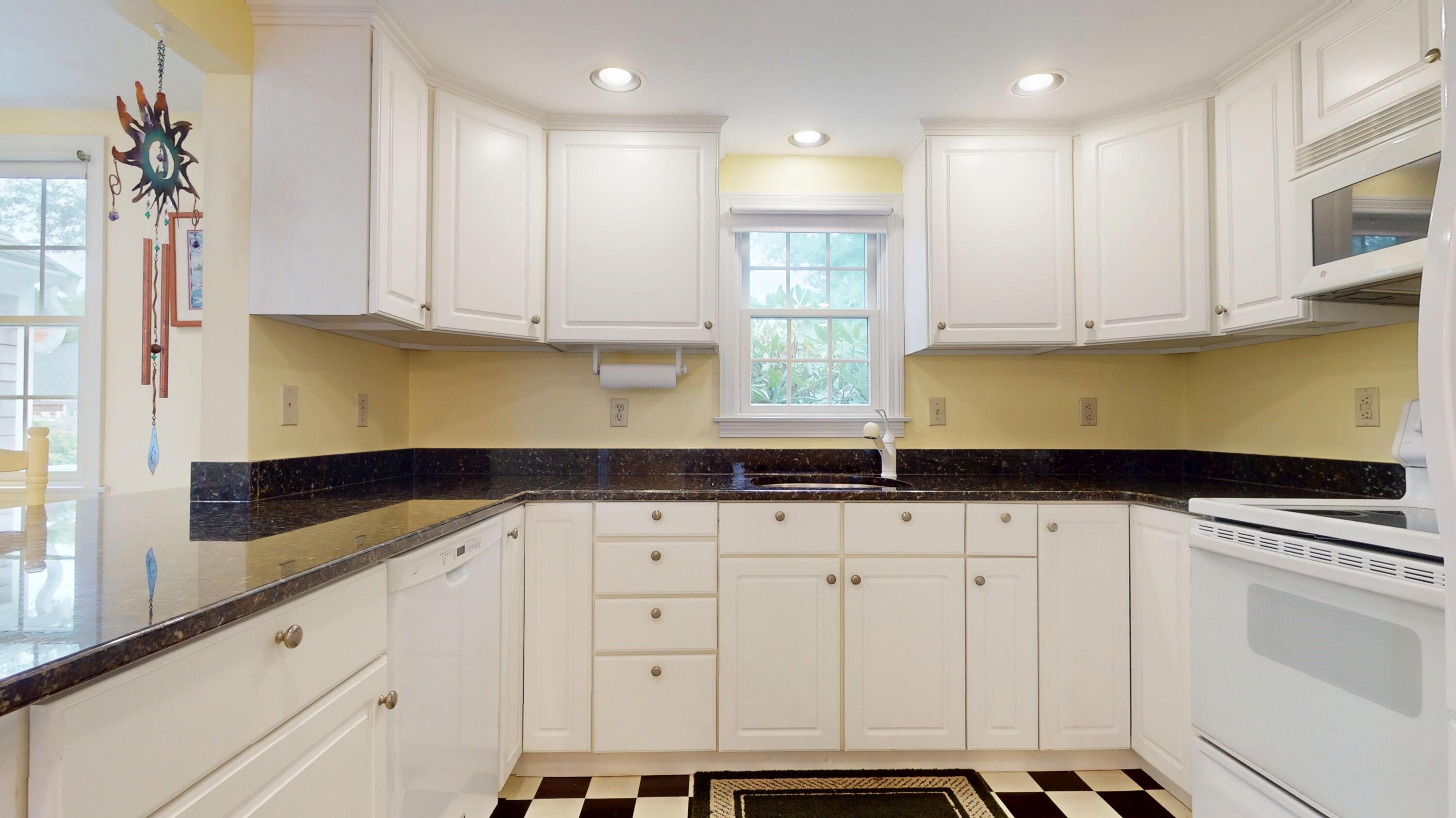 15 Woodside Park Road West Dennis, MA 02670 - Photo 6 of 35 a kitchen with granite countertop white cabinets and stainless steel appliances