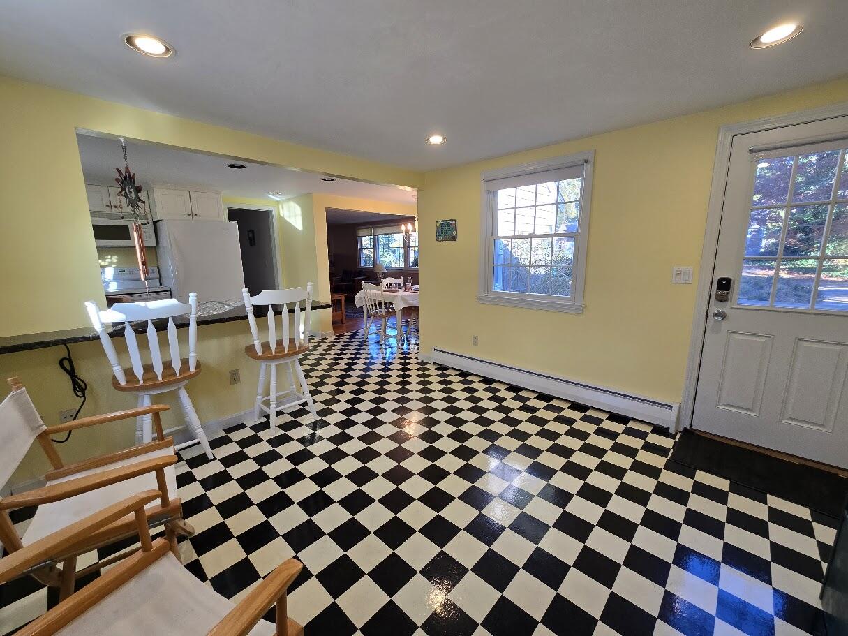 15 Woodside Park Road West Dennis, MA 02670 - Photo 8 of 35 a living room with a black white checkered floor with couches chair and a coffee table