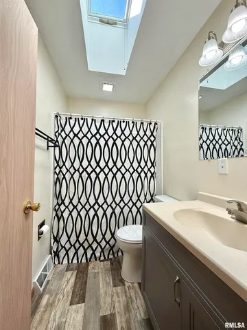 a bathroom with a sink a toilet and a mirror