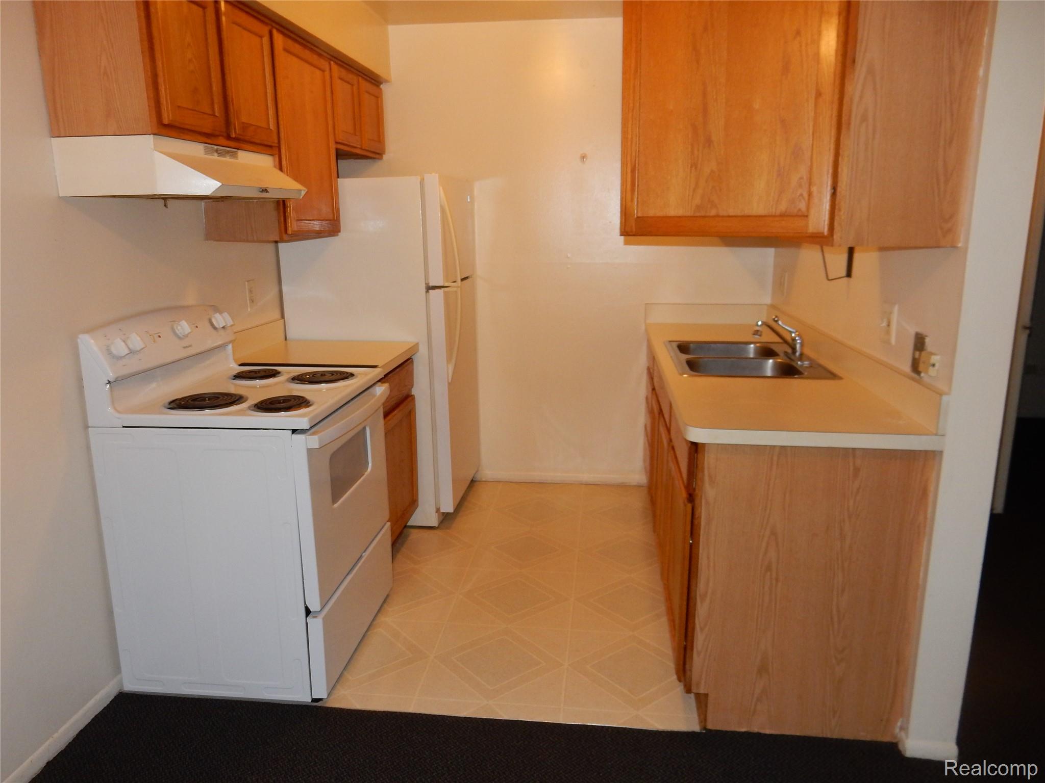 150 Arcola Street, Unit 3 Inkster, MI 48141 - Photo 6 of 15 Kitchen featuring white range with electric cooktop, light floors, and light countertops