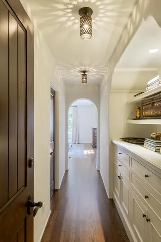 a view of a hallway with wooden floor
